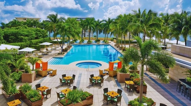 view of pool with a patio area and a community hot tub