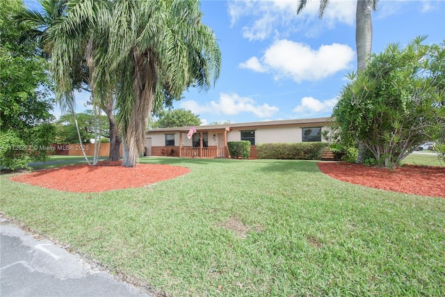 ranch-style home with a front lawn and stucco siding