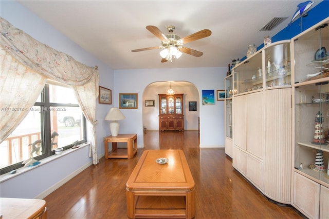 living room with ceiling fan and dark hardwood / wood-style flooring