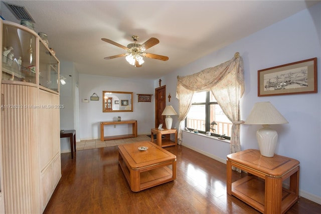 living room with wood-type flooring and ceiling fan