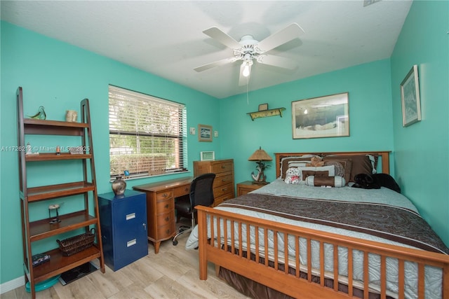 bedroom with light hardwood / wood-style floors and ceiling fan