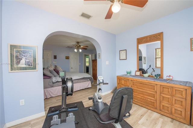 workout area with ceiling fan and light hardwood / wood-style flooring