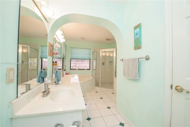 bathroom featuring tile patterned floors, vanity, and shower with separate bathtub