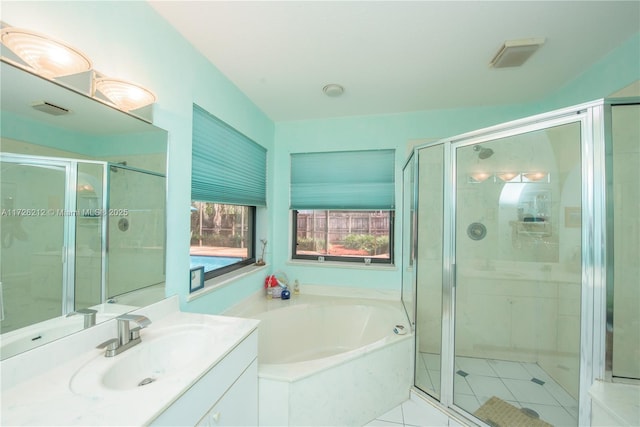 bathroom with independent shower and bath, tile patterned floors, and vanity