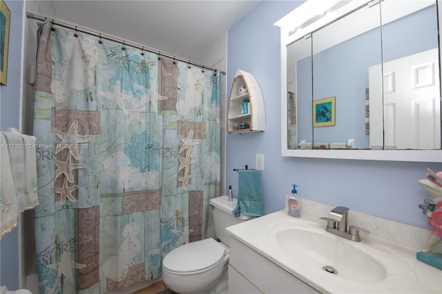 bathroom with toilet, curtained shower, and vanity