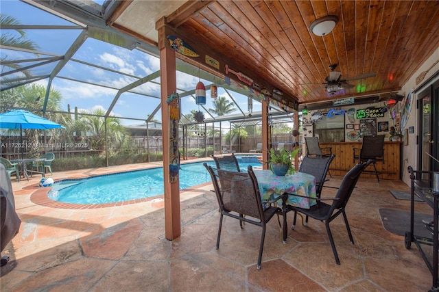 view of swimming pool featuring a fenced in pool, fence, ceiling fan, a lanai, and a patio area