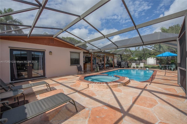 view of pool with an in ground hot tub, a patio area, french doors, a shed, and a lanai