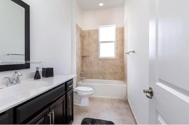 full bathroom with toilet, tile patterned floors, vanity, and tiled shower / bath combo