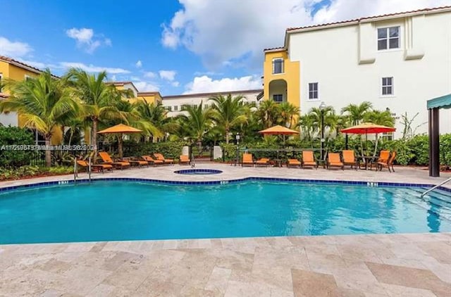 view of pool featuring a patio and a community hot tub