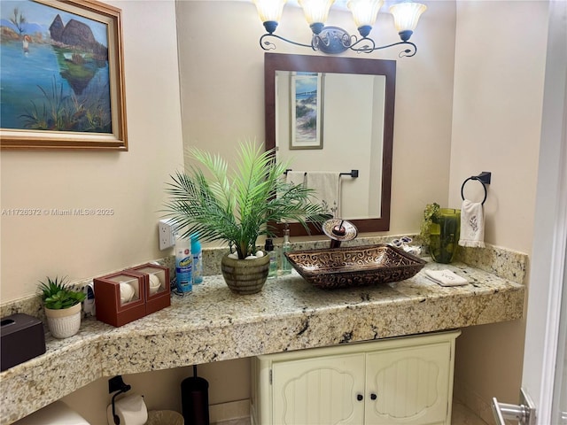 bathroom featuring vanity and a notable chandelier