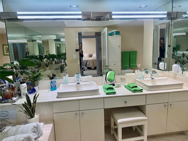 bathroom with tile patterned floors and vanity