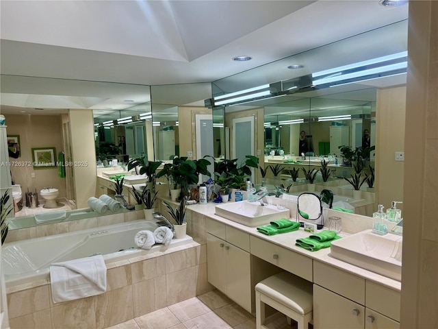 bathroom featuring a bidet, toilet, a relaxing tiled tub, tile patterned flooring, and vanity