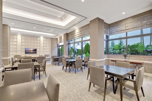 dining space featuring a raised ceiling and crown molding