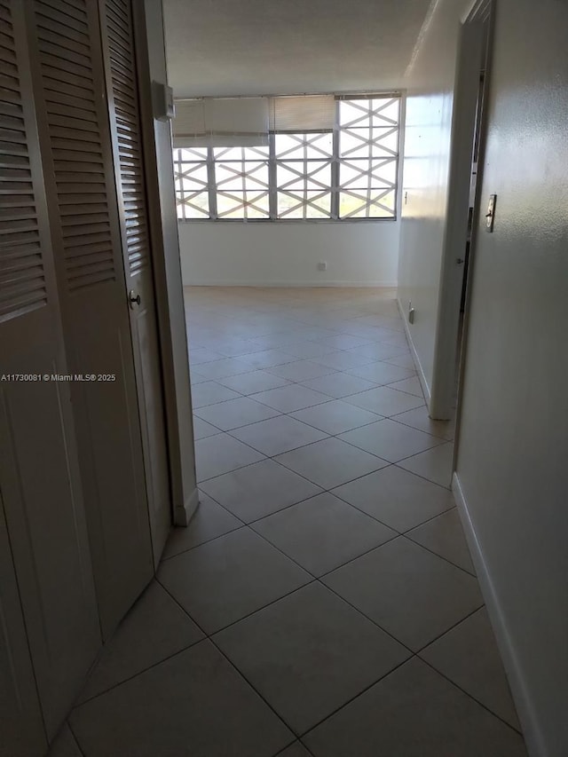 hall with light tile patterned flooring