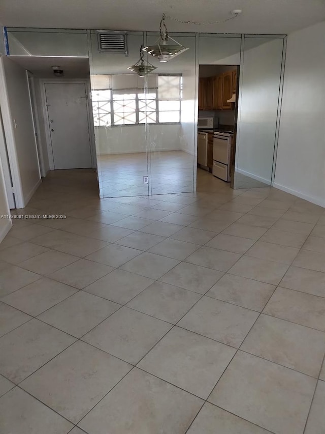 empty room with light tile patterned flooring