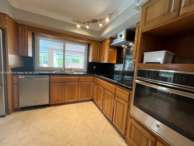 kitchen featuring sink, light tile patterned floors, wall chimney range hood, and appliances with stainless steel finishes