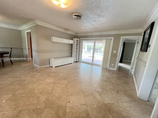 tiled empty room featuring ornamental molding and a textured ceiling