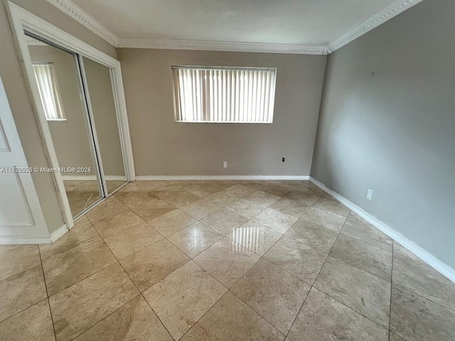 unfurnished bedroom featuring a closet and ornamental molding