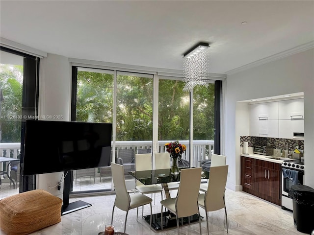 dining space featuring floor to ceiling windows and ornamental molding