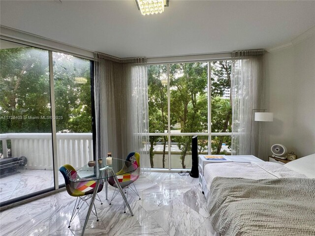 bedroom featuring access to exterior, floor to ceiling windows, and multiple windows