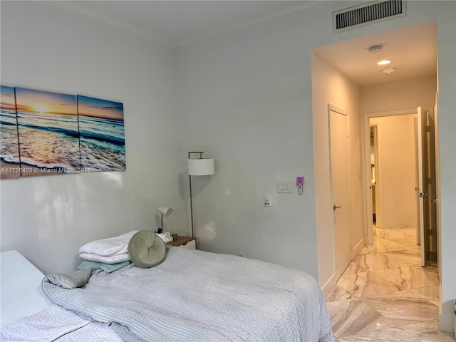 bedroom featuring crown molding and a closet