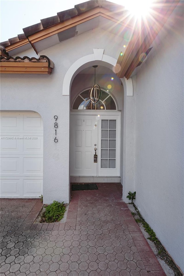 view of exterior entry featuring a garage