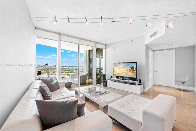 tiled living room featuring expansive windows