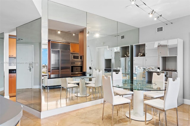 dining area with light tile patterned floors