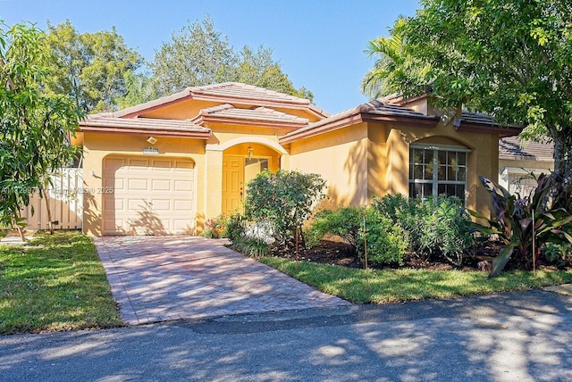 mediterranean / spanish home featuring a garage