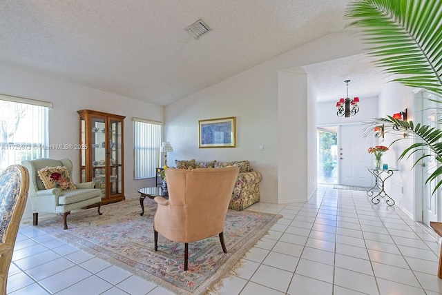 tiled living room featuring lofted ceiling and a textured ceiling