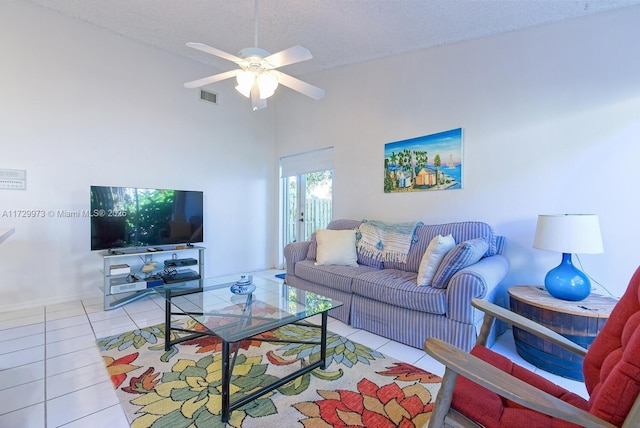 living room with high vaulted ceiling, a textured ceiling, tile patterned floors, and ceiling fan