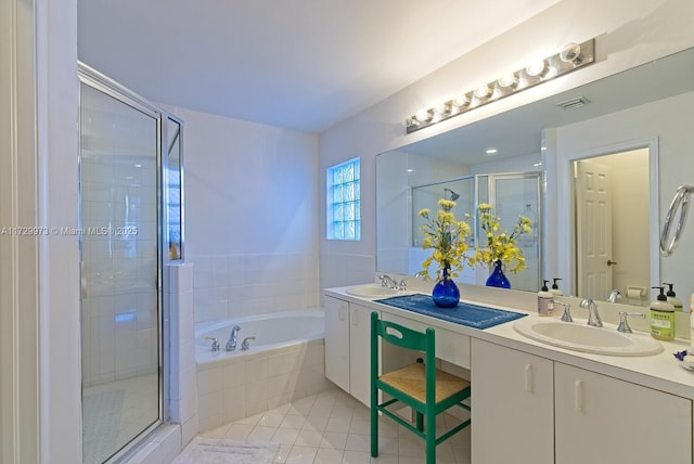 bathroom with independent shower and bath, vanity, and tile patterned floors