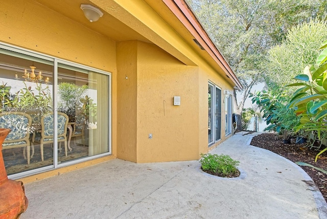 view of property exterior with a patio area