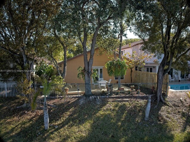 exterior space with a fenced in pool