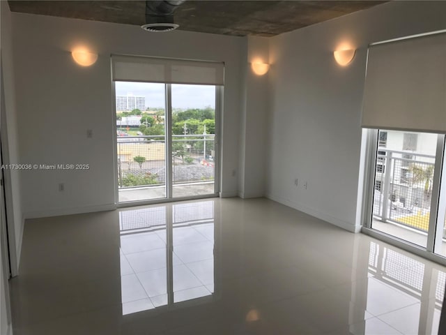 unfurnished room with tile patterned floors