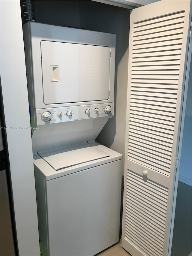 laundry area with stacked washer / drying machine