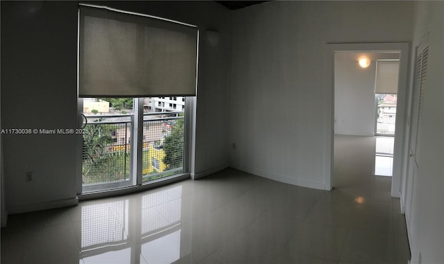 spare room featuring a healthy amount of sunlight and tile patterned flooring