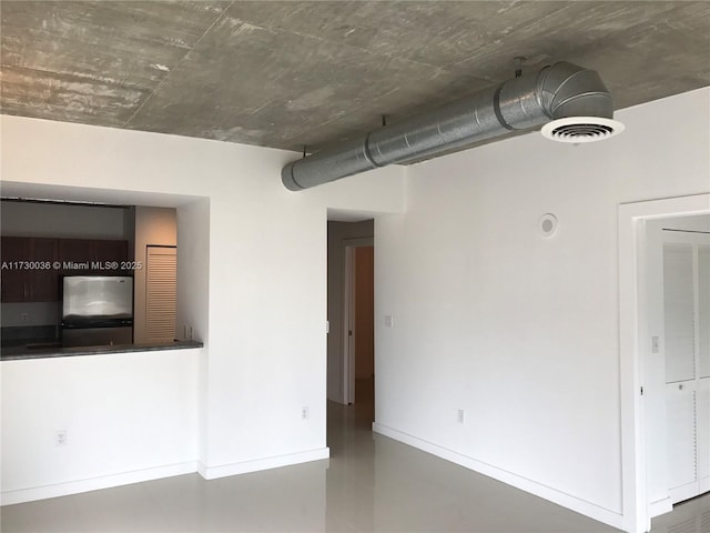 spare room featuring concrete flooring