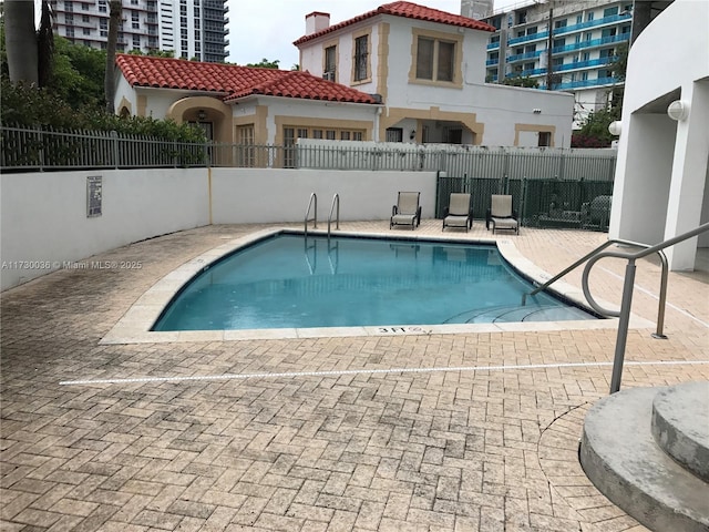 view of swimming pool featuring a patio area