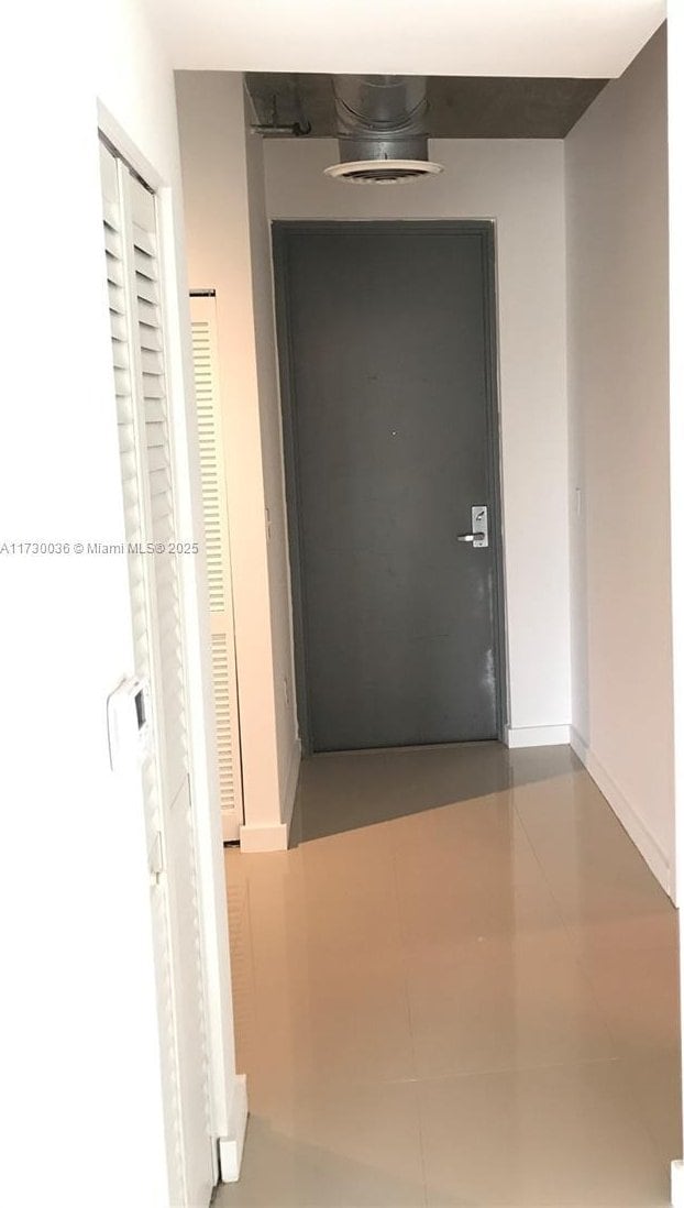 hallway featuring tile patterned flooring