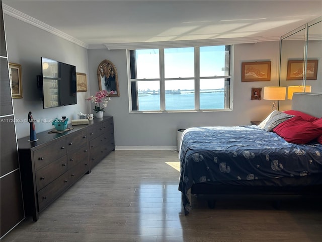 bedroom featuring ornamental molding and hardwood / wood-style floors