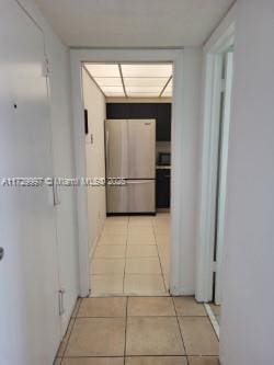 hall with light tile patterned floors