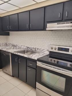 kitchen featuring stainless steel electric stove, black dishwasher, sink, backsplash, and light tile patterned floors