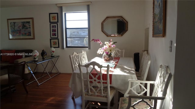 dining space featuring wood-type flooring