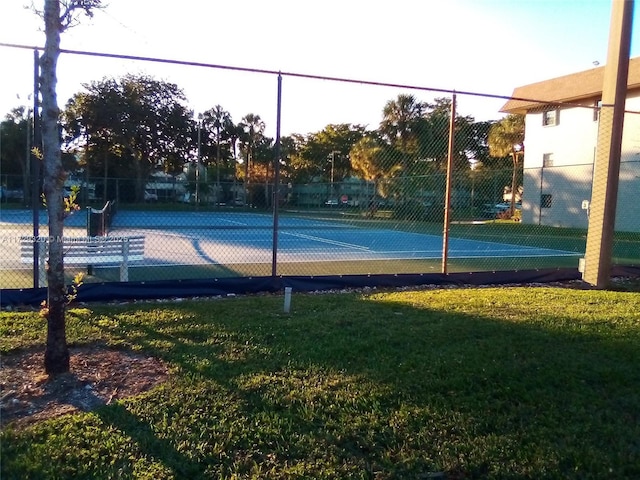 view of sport court featuring a yard