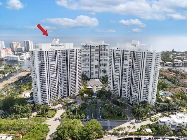 view of building exterior with a water view and a city view