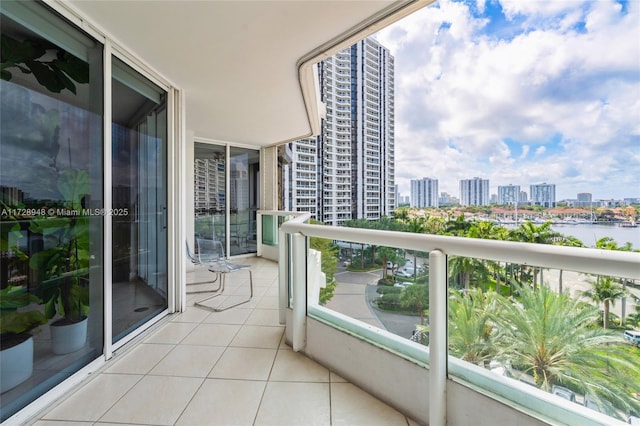 balcony featuring a city view and a water view