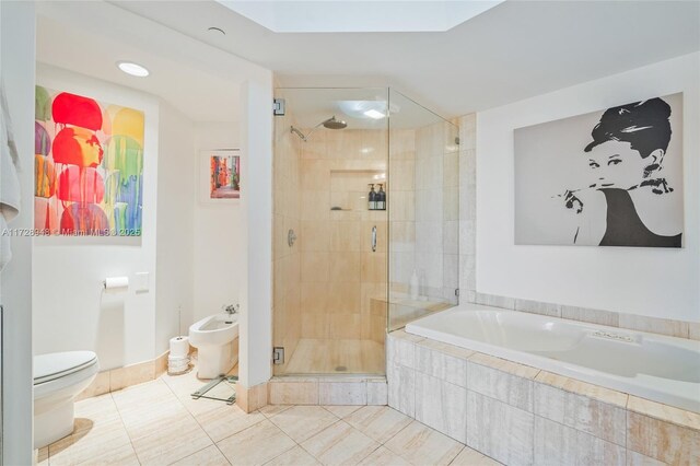 bathroom featuring a stall shower, a garden tub, toilet, and tile patterned floors