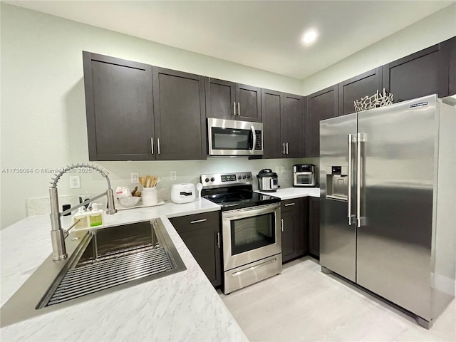 kitchen with sink, dark brown cabinets, and appliances with stainless steel finishes