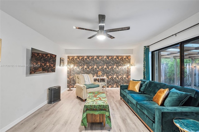 living room featuring light wood-type flooring and ceiling fan